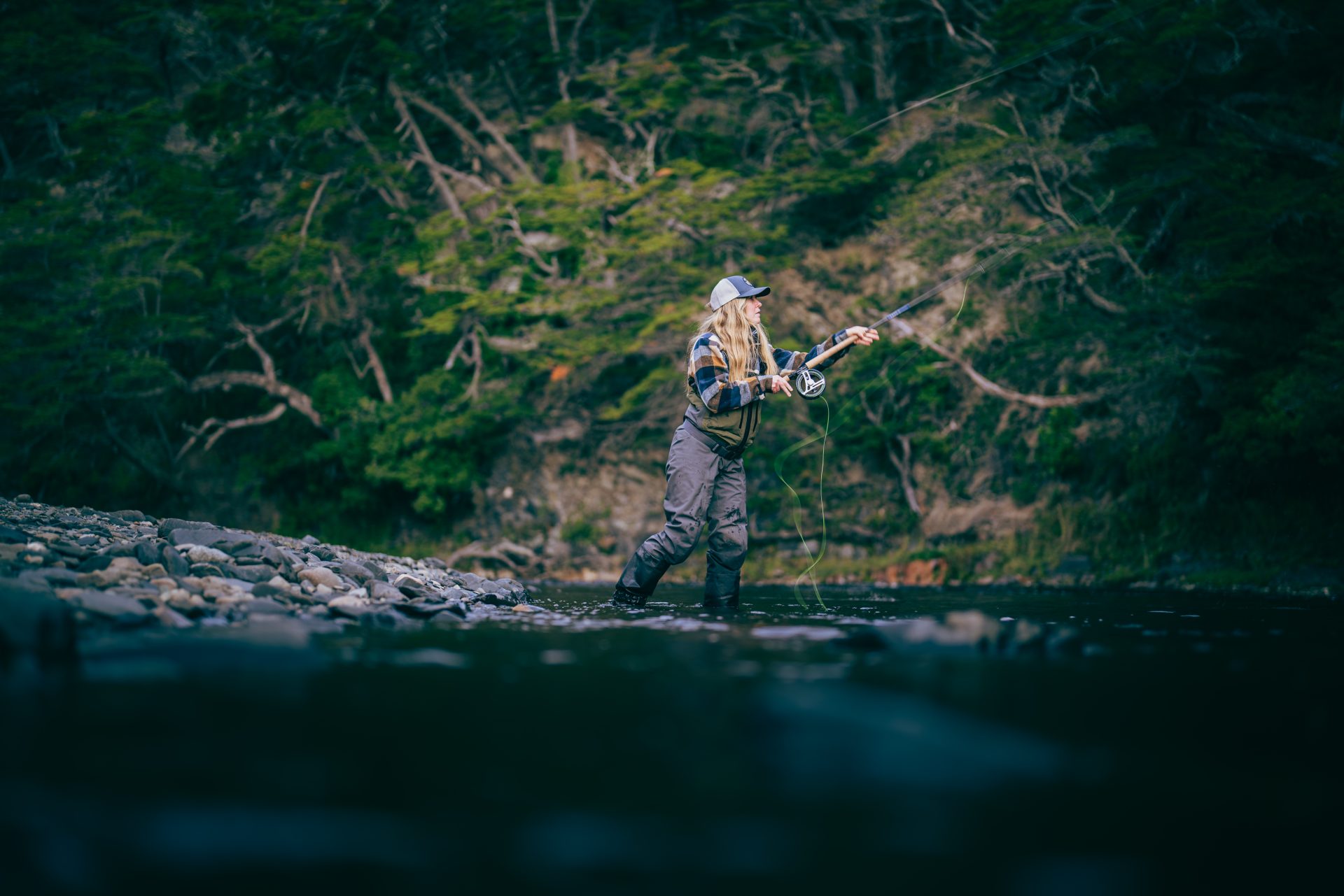 A female angler casts with a ZT Travel rod.